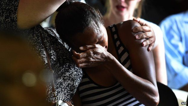 A woman weeps at a church service for eight children killed in Cairns