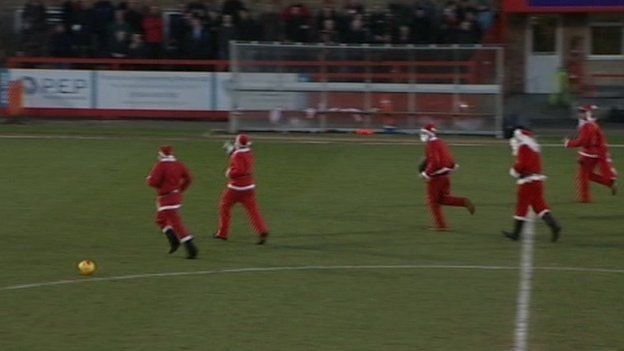 Father Christmases invading pitch