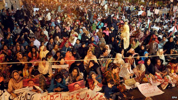 Supporters of opposition political party Mutahida Qaumi Movement (MQM) listen to a speech of their leader Altaf Hussain during a protest against the attack on Army Public School in Karachi, Pakistan, 21 December 2014.