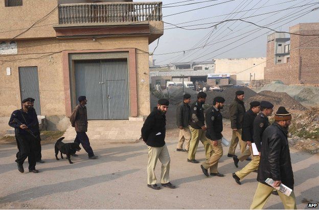 Pakistani police search around the school in Peshawar, 21 December