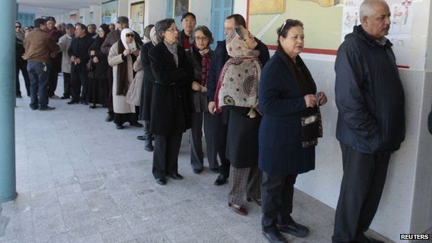 Tunisians queue to vote in the country's historic presidential elections
