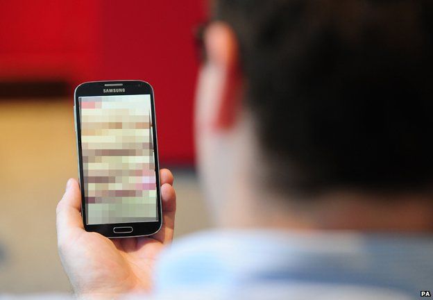 Man looks at pixellated smartphone