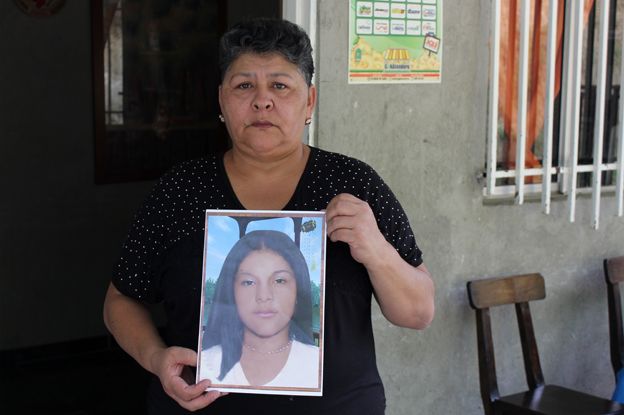 Margarita Restrepo holding a picture of her daughter, Carol