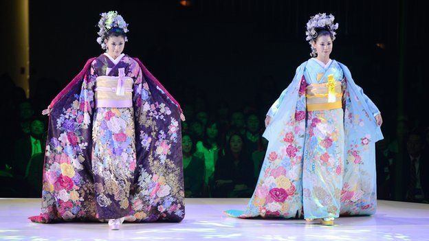 Models wearing bridal kimonos at a fashion show