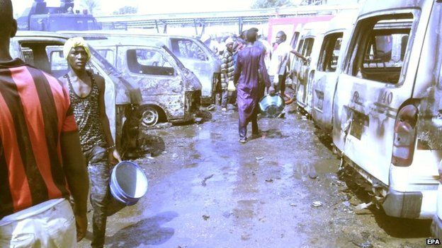 People inspect the site of a bomb blast at a bus station in Gombe, north-eastern Nigeria - 31 October 2014