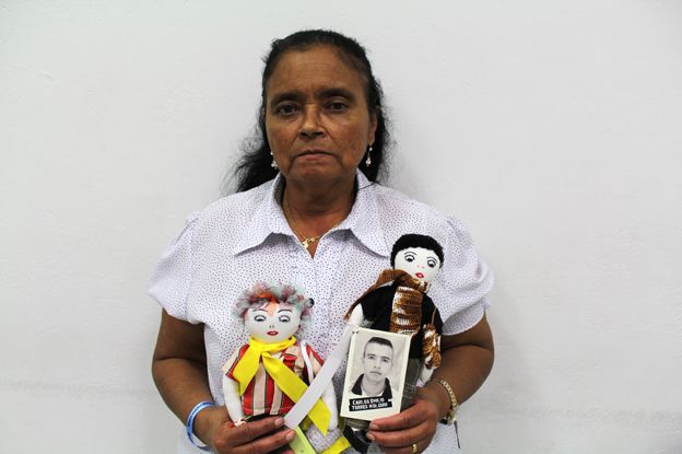 Maria Gloria Holguin with two dolls