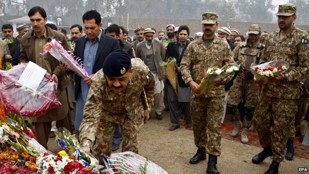 Pakistani soldiers lay floral wreaths for the school children who were killed in a terror attack at the army-run school, in Peshawar (21 December 20143)