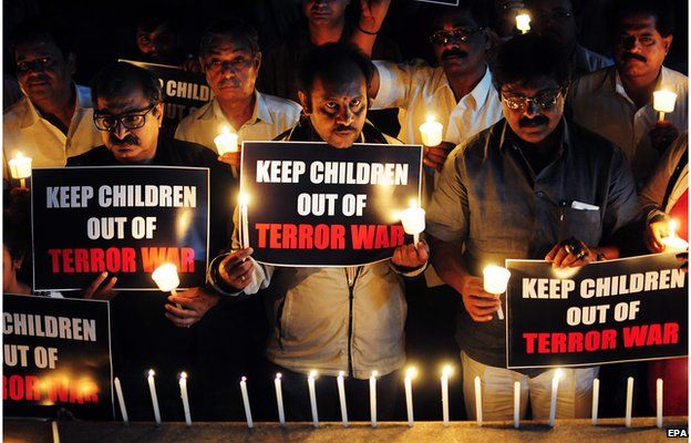 Indian journalists and NGO workers hold a candlelight vigil for the victims of the Taliban attack on a Pakistani school, Bangalore, India, 17 December 2014