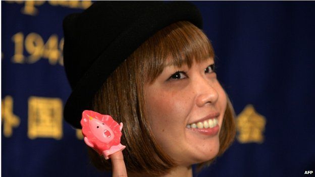 This file picture taken on 24 July 2014 shows Japanese artist Megumi Igarashi showing a small mascot shaped like a vagina "Manko-chan" at a news conference in Tokyo.