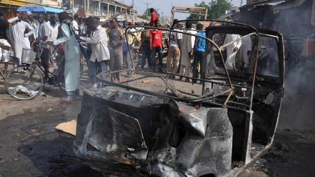 People gather at the scene of an explosion, at the central market, in Maiduguri, Nigeria (July 2014)