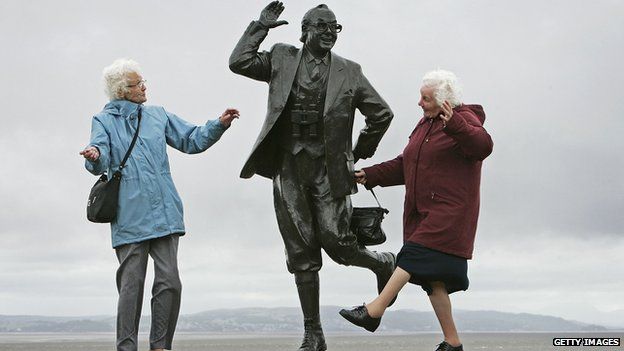 Old ladies dancing by statue of Eric Morecambe