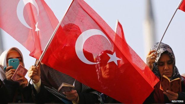 Supporters of the Gulen movement wave Turkish flags as they gather outside the Justice Palace in Istanbul - 19 December 2014