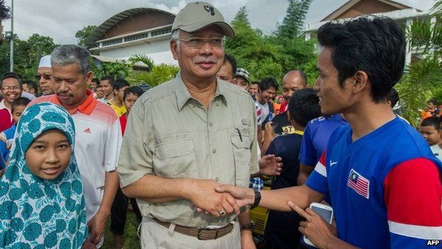 The Malaysian Prime Minister, Najib Razak, at an evacuation centre following heavy flooding in the country