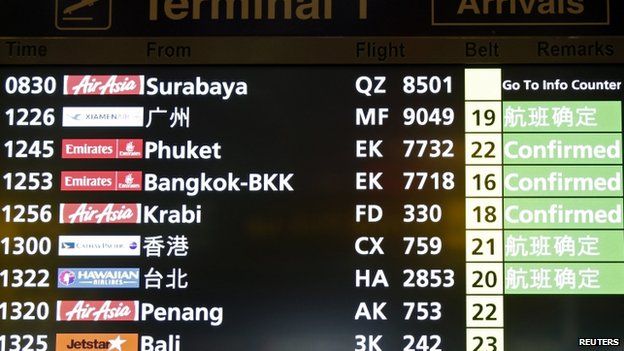 The flight arrivals board at Changi Airport in Singapore, where the AirAsia flight was due