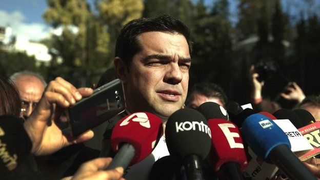 Alexis Tsipras, leader of the Syriza party, talks to reporters outside the parliament building in Athens - 29 December 2014
