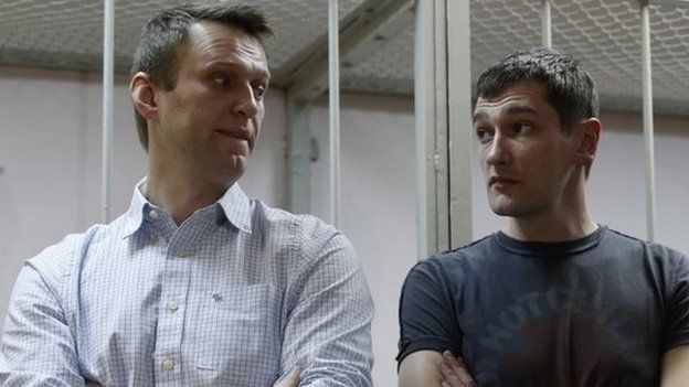 Russian opposition activist and anti-corruption crusader Alexei Navalny, 38, left, and his brother Oleg Navalny stand at a court in Moscow, Russia, Tuesday, Dec. 30, 2014