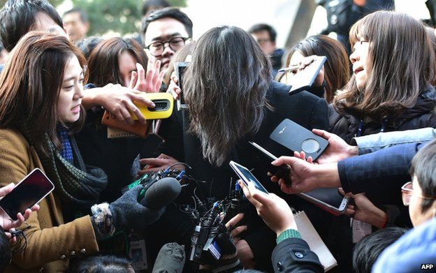 Cho Hyun-Ah (centre) is surrounded by journalists outside a court in Seoul on 30 December 2014