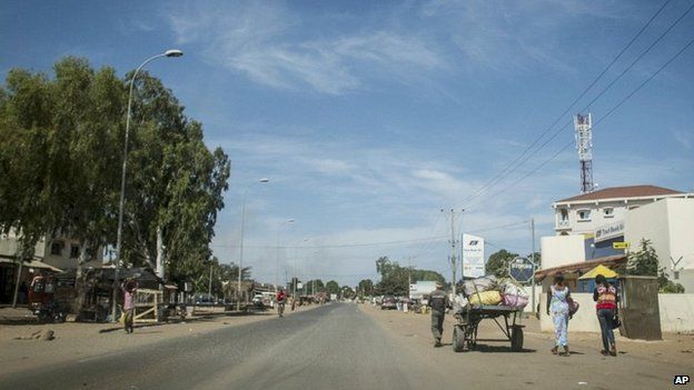 Residents walk on an empty street in Banjul, Gambia - 30 December 2014
