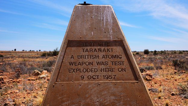 A sign marking the explosion stands in the test site