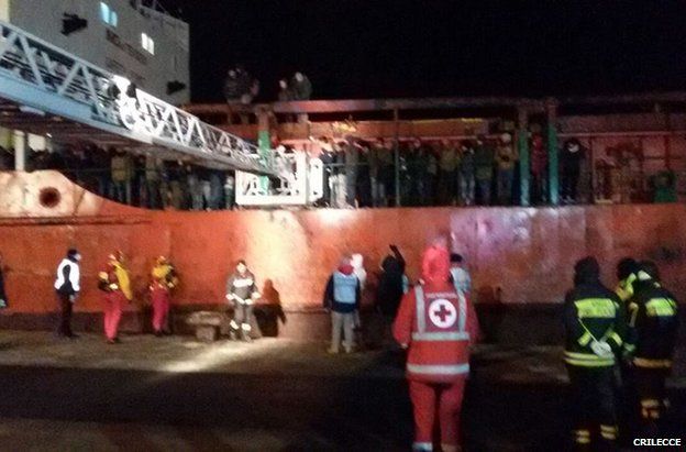 Red Cross personnel wait on the dock as the migrants prepare to leave the ship in Gallipoli, Italy, 31 December