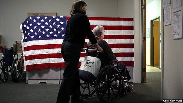 US flag and pensioner in wheelchair