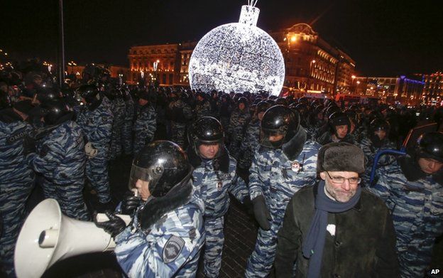 Police prepare to push supporters of Russian opposition activist and anti-corruption crusader Alexei Navalny away during an unsanctioned protest in Moscow, Russia, 30 December 2014
