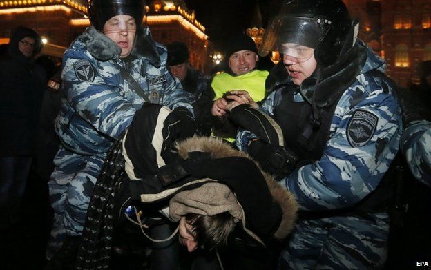 Policemen detain a supporter of opposition leader Alexei Navalny during rally central Moscow, Russia, 30 December 2014