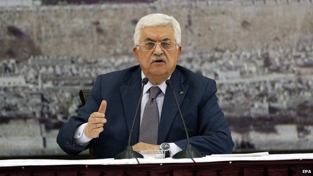 Palestinian President Mahmoud Abbas during a meeting to sign more than 20 international treaties, including the Rome Statute of the International Criminal Court, in the West Bank city of Ramallah, 31 December 2014