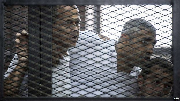Al-Jazeera news channel's Australian journalist Peter Greste (left) and his colleagues, Egyptian-Canadian Mohamed Fadel Fahmy (centre) and Egyptian Baher Mohamed (23 June 2014)