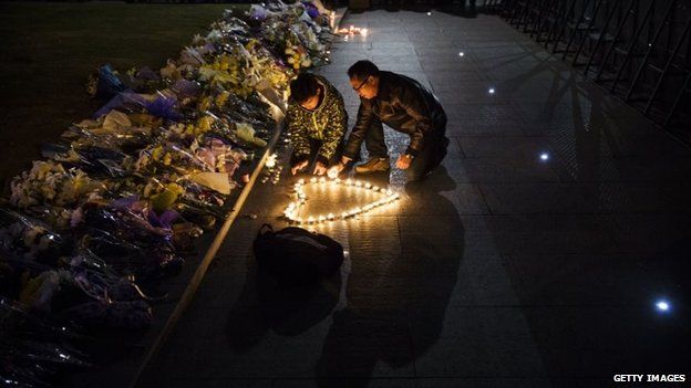 Mourners light candles in the shape of a heart at a makeshift memorial at the site of a stampede on the Bund in Shanghai, China, 1 January 2015