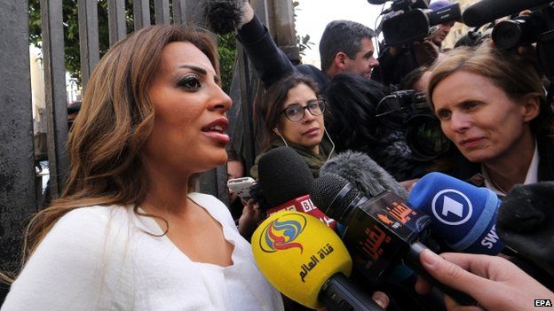 Marwa Omara (left), fiancee of imprisoned al-Jazeera Egyptian-Canadian journalist Mohamed Fahmy, speaks to the press outside the High Court (01 January 2015)