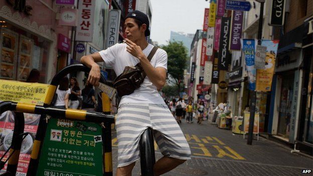 A man smoking in the street in Seoul