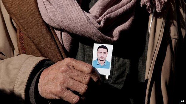 Coptic Christian Samir Mujeed holds a photo of his son, Girgis Samir, who was abducted in Libya - 5 January 2015