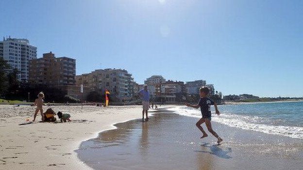 Children enjoy the weather on a beach in Sydney