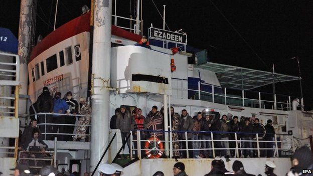 Italian police looks at migrants aboard the cargo ship "Ezadeen" after the vessel arrived in the southern Italian port of Corigliano, Italy, 3 January 2015