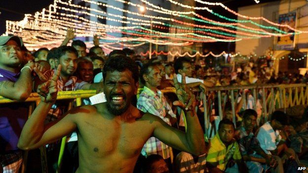 Sri Lankan supporter of Sri Lanka"s main opposition presidential candidate Maithripala Sirisena gestures during a rally in Colombo early on January 6, 2015.