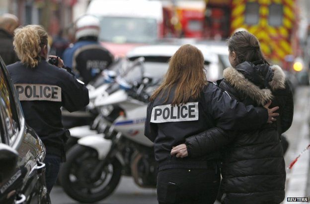 Police officers near the site of a shooting in Montrouge, south of Paris, 8 January