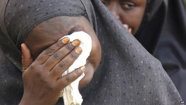 A woman mourns the shooting of a Muslim cleric in Kampala, Uganda - December 2014
