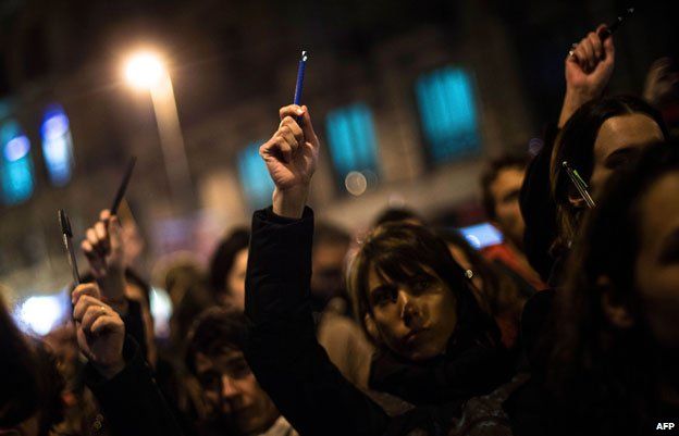 Demonstrators holding pens and pencils in Barcelona