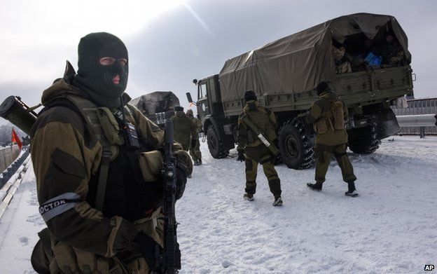 A pro-Russian rebel guards the road near the Airport of Donetsk on 6 January 2015.