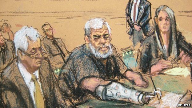 A courtroom sketch shows Abu Hamza, 56, seated with his defense lawyers 9 January 2015
