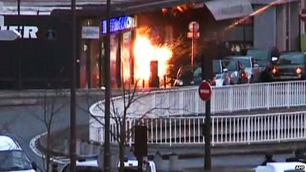 A screengrab taken from an AFP TV video shows a general view of members of the French police special forces launching the assault at a kosher grocery store in Porte de Vincennes, eastern Paris, on January 9, 2015