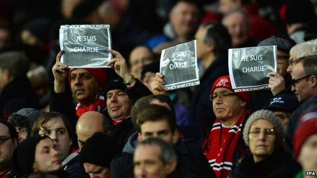 Manchester United fans hold up signs during a match against Southampton at Old Trafford
