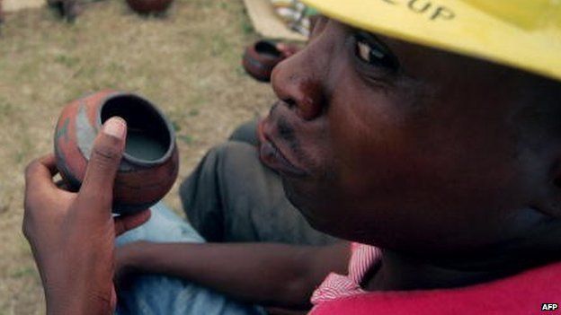 A man drinks traditional beer in Polokwane, South Africa, on 26 February 2010