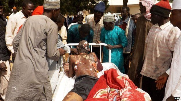 A man injured in a suicide blast is transported on a bed at the General Hospital in northeast Nigerian town of Potiskum on 12 January 2015