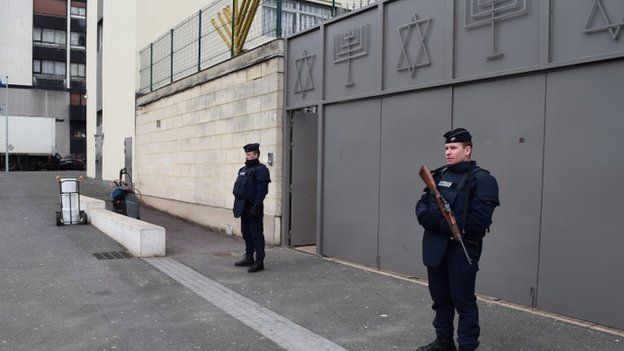 Policemen on guard outside a synagogue in Sarcelles