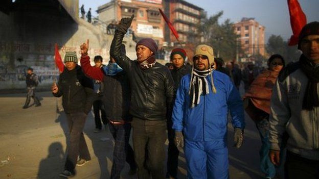 Protesters march along a deserted road during the general strike in Kathmandu 13 January 2015