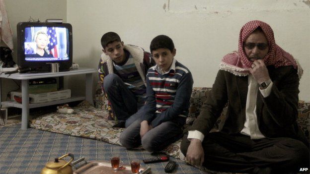 A picture taken on March 8, 2012, shows Syrian refugee Abu Osama and his sons in Ramtha city, north of Amman
