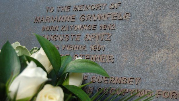 Flowers laid at Guernsey memorial for three Jewish women deported from the island during the German occupation in World War 2. Later all three died in Auschwitz