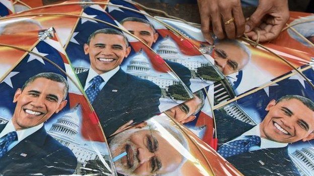 An Indian shopkeeper strings kites with images of Indian prime minister Narendra Modi (C) and US President Barack Obama (L and R) in Mumbai on January 7, 2015.